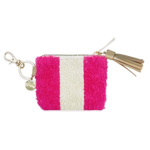 May include: A pink and white striped fuzzy coin purse with a gold zipper and a gold tassel.