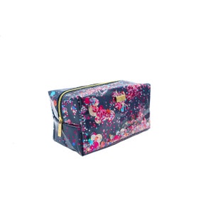 May include: A navy blue zippered cosmetic bag with a colorful confetti print. The bag has a gold zipper and a gold logo.