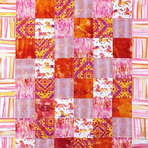 May include: A patchwork quilt with a white background and squares of pink, orange, and yellow fabric. The quilt is made up of different patterns, including stripes, polka dots, and floral designs.