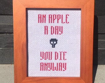 An Apple A Day You Die Anyway 4 x 5 inch finished cross stitch in walnut wood frame