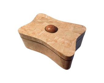 May include: A light pink, star-shaped, mosaic trinket box with a brass trim and a round, red stone knob on the lid.