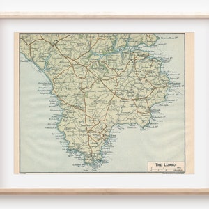 Puede incluir: Un mapa vintage de The Lizard, una península en Cornualles, Inglaterra. El mapa muestra carreteras, pueblos y características costeras. El mapa está impreso en marrón, verde y azul sobre un fondo blanco.