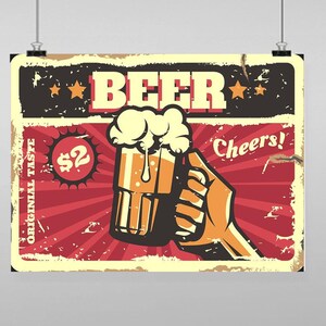 Puede incluir: Un cartel de estilo vintage que anuncia cerveza. El cartel muestra una mano sosteniendo un vaso de cerveza con espuma en la parte superior. El cartel es rojo, amarillo y negro con las palabras "Cerveza" y "¡Salud!" en él. El precio es de 2 €.