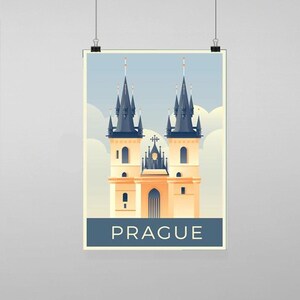 May include: A poster featuring a stylized illustration of Prague. The artwork depicts a cream-colored building with two tall, dark blue spired towers. The word "PRAGUE" is printed in white on a dark blue banner at the bottom.