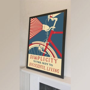 Puede incluir: Un póster de estilo vintage con una bicicleta roja sobre un fondo azul. El póster dice "La simplicidad es la clave para una vida exitosa".