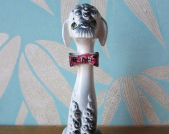 Mid-century ceramic poodle in spotty bow tie sitting tall/proud