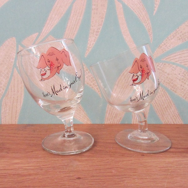 Two rare mid-century Wonky "Here's Mud in Your Eye" drunk elephant sherry/tot glasses