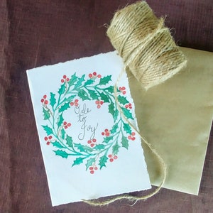 Cores de água pintadas à mão originais e ode de tinta para cartões de Natal Joy