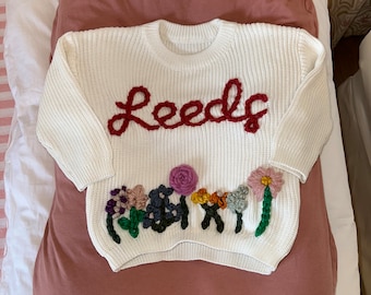 Personalized embroidered name sweater with spring flower design