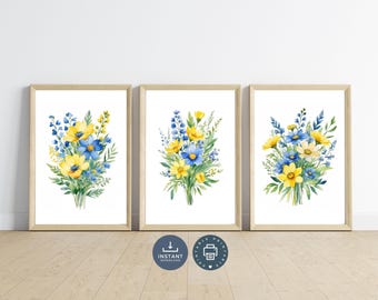 May include: Three printable art prints featuring watercolor bouquets of yellow and blue flowers. The prints are framed in light wood frames and are displayed on a white wall.
