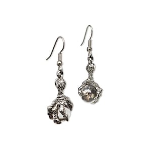May include: Silver claw earrings with clear glass beads. The claws are detailed and the beads are round.