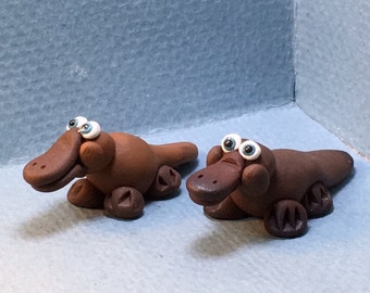 Platypus miniatures, with their ducked bills, webbed feet and otter tails!. Your choice of dark or light