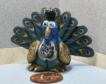 Peacock miniature made with polymer clay caned tail feathers. Gilded with metalic powders.