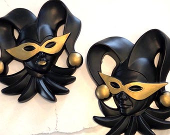 A pair of vintage chalkware harlequin masks in gold.