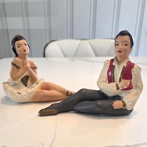 Vintage pair of a chalkware man and woman ballet dancers sitting figurines from Universal Statuary.