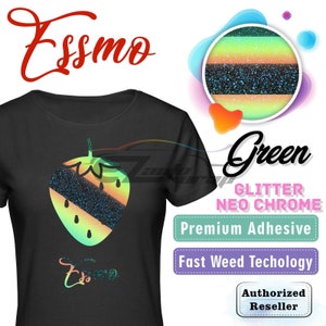 May include: Black t-shirt with a green, black, and yellow glitter strawberry design. The text "Essmo" is printed on the shirt. The image also includes text that says "Green Glitter Neo Chrome", "Premium Adhesive", "Fast Weed Technology", and "Authorized Reseller".