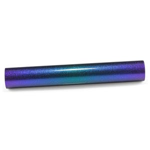 May include: A cylindrical roll of heat transfer vinyl featuring a smooth, glittery finish that transitions in color from a deep purple at the edges to a vibrant teal blue in the center, creating a seamless gradient effect across the surface.