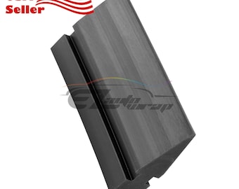 May include: Black vinyl wrap squeegee tool with a black rubber blade. The tool has a black plastic handle and a black rubber grip.