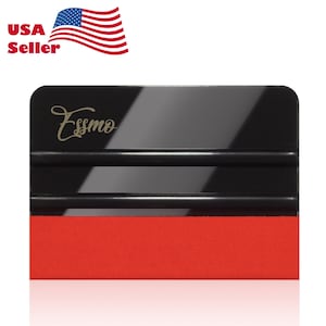 May include: A black rectangular squeegee tool featuring two horizontal ridges and a wide red felt edge at the bottom. The brand name Essmo is printed in a gold cursive font on the upper left side of the black surface, which has a glossy finish.