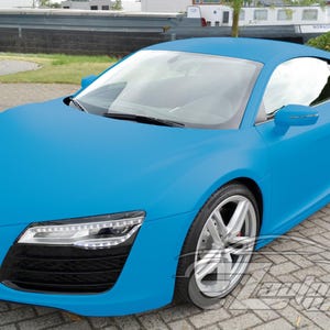 May include: A matte light blue sports car featuring a sleek aerodynamic body, silver alloy wheels, and black side air intake panels. The front end displays sharp LED headlights and a black grille. A watermark is visible in the bottom right corner.