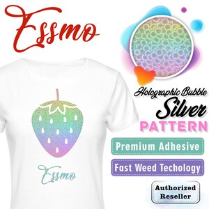 May include: A white t-shirt with a holographic silver strawberry design. The design features a rainbow gradient and a bubble pattern. The text "Essmo" is printed on the shirt in a cursive font. The shirt is advertised as having a premium adhesive and fast weed technology.