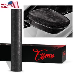May include: A roll of black carbon fiber vinyl wrap with a textured pattern. The image also shows a car side mirror wrapped in the same material and a black box with the red text "Essmo". The American flag and "USA Seller" are in the top left corner.