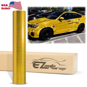 May include: A roll of gold car wrap vinyl with a diamond pattern. The vinyl is shown next to a yellow car with a black box that says "EZ auto wrap".