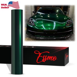 May include: A cylindrical roll of dark metallic green vinyl wrap film positioned next to a black rectangular box with the red text Essmo. The box displays a car with a glossy dark green finish, showcasing the reflective quality of the vinyl wrap.