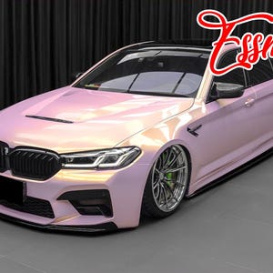May include: A pink pearl-effect BMW 5 Series sedan with black accents, a black grille, and black wheels. The car has a custom body kit and a lowered suspension.