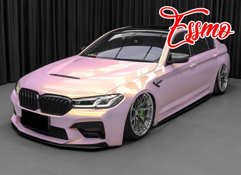 May include: A pink pearl-effect BMW 5 Series sedan with black accents, a black grille, and black wheels. The car has a custom body kit and a lowered suspension.