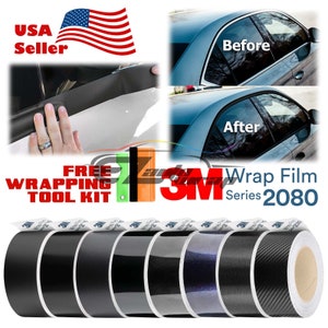 May include: A set of six rolls of 3M Wrap Film Series 2080 in black, black with a sparkle finish, black with a carbon fiber pattern, and blue with a sparkle finish. The rolls are labeled with the 3M logo and the product name. The image also shows a car window before and after being wrapped with the film.