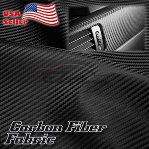 May include: Black carbon fiber fabric with a woven texture. The fabric has a subtle sheen and is ideal for upholstery, automotive interiors, and other applications.