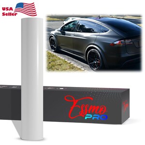 May include: A roll of white vinyl wrap material next to a black car. The car is a dark gray color with black wheels. The box has the text "Essmo PRO" in red and blue.