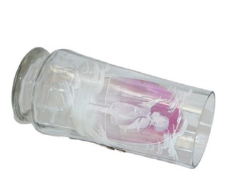 May include: A clear glass vase with a pink and white etched design. The vase has a round bottom and a cylindrical shape.
