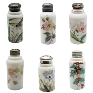 May include: Set of six antique white porcelain salt shakers with metal lids. Each shaker features a different hand-painted floral or insect design in various colors, including pink, green, and yellow. The shakers are cylindrical in shape.