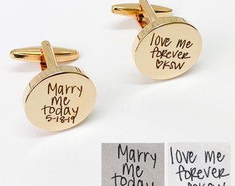May include: Two gold cufflinks with engraved messages. One cufflink says "Marry me today 5-18-19" and the other says "Love me forever ♡KSW".