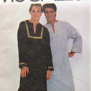 May include: A white ceramic mug with a black handle and the text "But First, Coffee" in a handwritten style. The mug is on a white surface. The mug is approximately 4 inches tall.