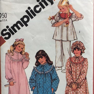 May include: Vintage Simplicity sewing pattern for girls' sleepwear. The pattern features illustrations of various nightgowns and pajamas, including a pink gown, a blue quilted robe, and a floral-print nightdress. The pattern is labeled "Girls & Chubbies".