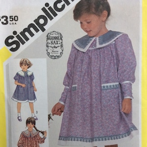May include: Simplicity sewing pattern for a Gunne Sax Jessica dress. The dress is a floral print with a Peter Pan collar and long sleeves. The pattern includes illustrations of the dress in different colors and styles.