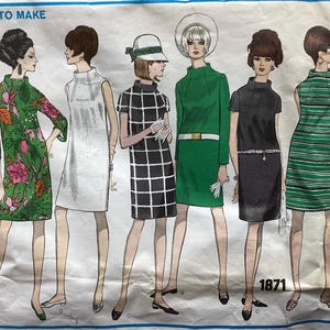 May include: Vintage sewing pattern featuring six women's dresses. The dresses include a green floral print, white, black and white checkered, solid green, black, and green striped designs. The pattern is labeled "EASY TO MAKE" and includes the number "1871".