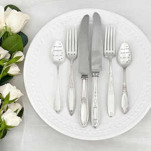 May include: A set of five silver-plated utensils, including two forks, two spoons, and a butter knife. The spoons are engraved with the text "Mr & Mrs Leonard 9.21.21" and "Mr & Mrs Leonard 9.21.21" and the forks are engraved with the text "A ♥ K" and "A ♥ K".