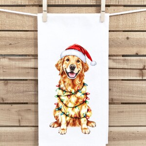 May include: A golden retriever dog wearing a red Santa hat and wrapped in Christmas lights. The dog is sitting on a white background.
