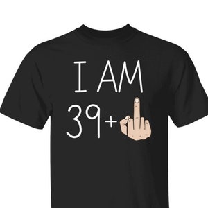 May include: Black t-shirt with white text that reads "I AM 39+" and a cartoon hand giving the middle finger.