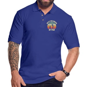 May include: A royal blue polo shirt with a vintage-style graphic of a golfer and the text "Best Grandpa By Par".