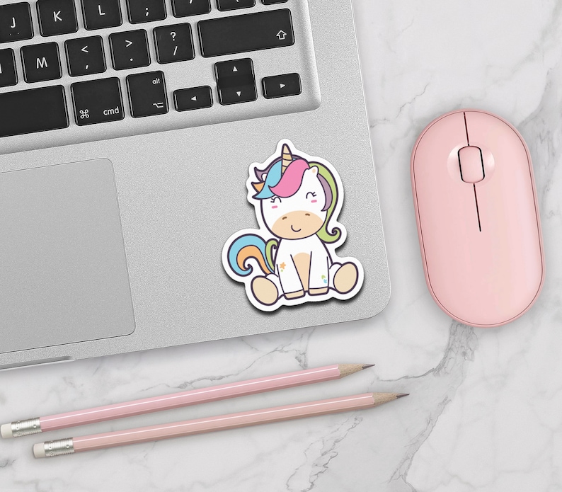 May include: A sticker featuring a cartoon unicorn with a rainbow mane and tail. The unicorn is sitting down with its eyes closed and a smile on its face. The sticker is on a white background.