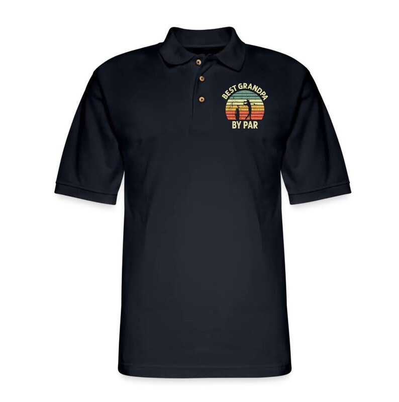 May include: Black polo shirt with a vintage-style graphic that says "Best Grandpa By Par" with a silhouette of a golfer and a sunset.