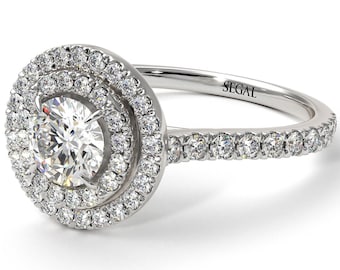 Könnte beinhalten: Ein Verlobungsring aus Weißgold mit einem runden Diamanten in der Mitte, der von zwei Reihen kleinerer Diamanten umgeben ist. Die Ringschiene ist ebenfalls mit Diamanten besetzt.
