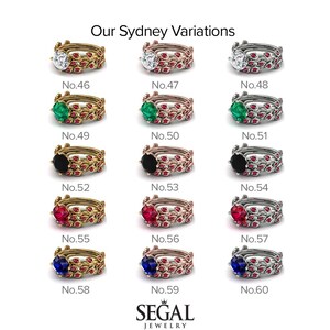 May include: A set of 12 engagement rings featuring various coloured gemstones. The rings are all gold, rose gold, or silver. The gemstones include emerald, ruby, sapphire, black diamond, and white diamond. The rings are numbered 46 to 60.