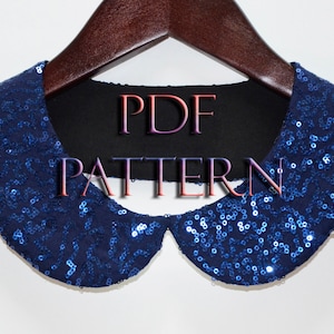 May include: A blue sequin collar with a black fabric backing. The collar is on a wooden hanger. The text "PDF PATTERN" is printed on the fabric backing.