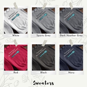 May include: Six different color sweatshirts with the text "Running on Borrowed Spoons" and a blue spoon graphic printed on the front. The colors are white, sports gray, dark heather gray, red, black, and navy.